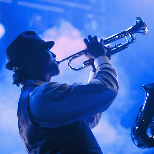 Musicians playing in jazz band on stage.