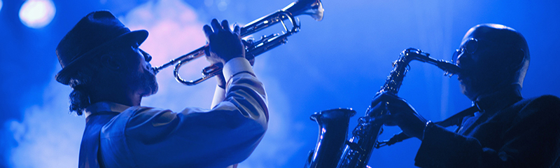 Musicians playing in jazz band on stage.