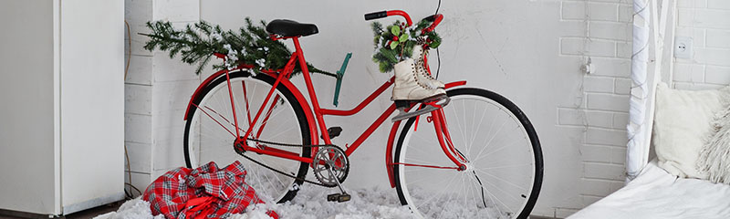 Red decor bicycle with ice skates on Christmas decoration at studio.
