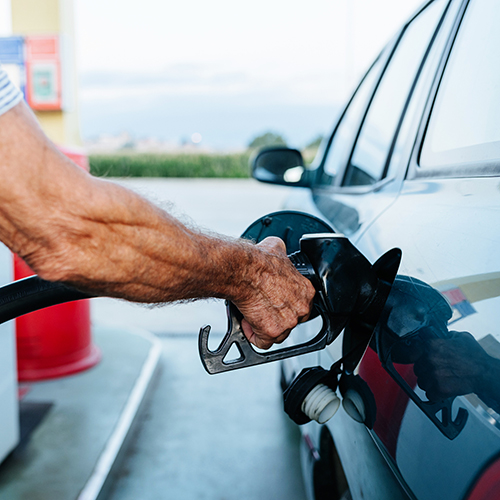 Man filling the tank of his car at the gas station. 