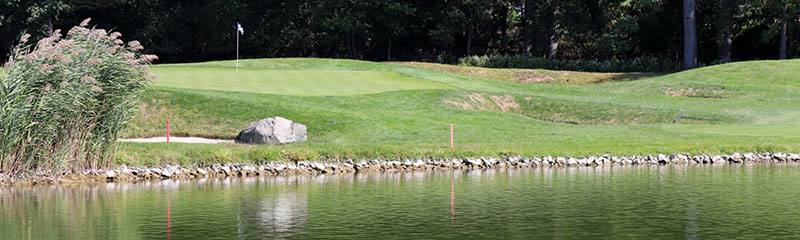 Golf course with lake view.