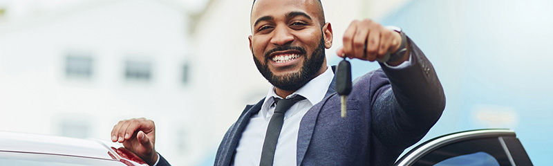 Shot of a well-dressed man holding the keys to his new car