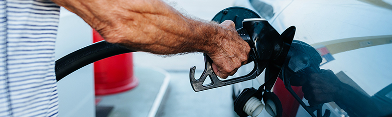 Man filling the tank of his car at the gas station.