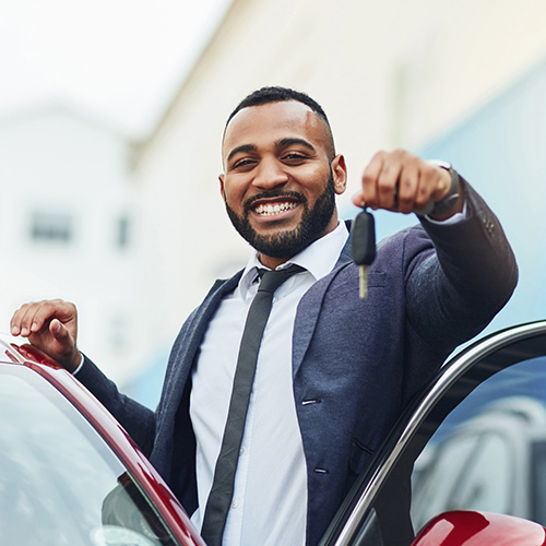 Shot of a well-dressed man holding the keys to his new car